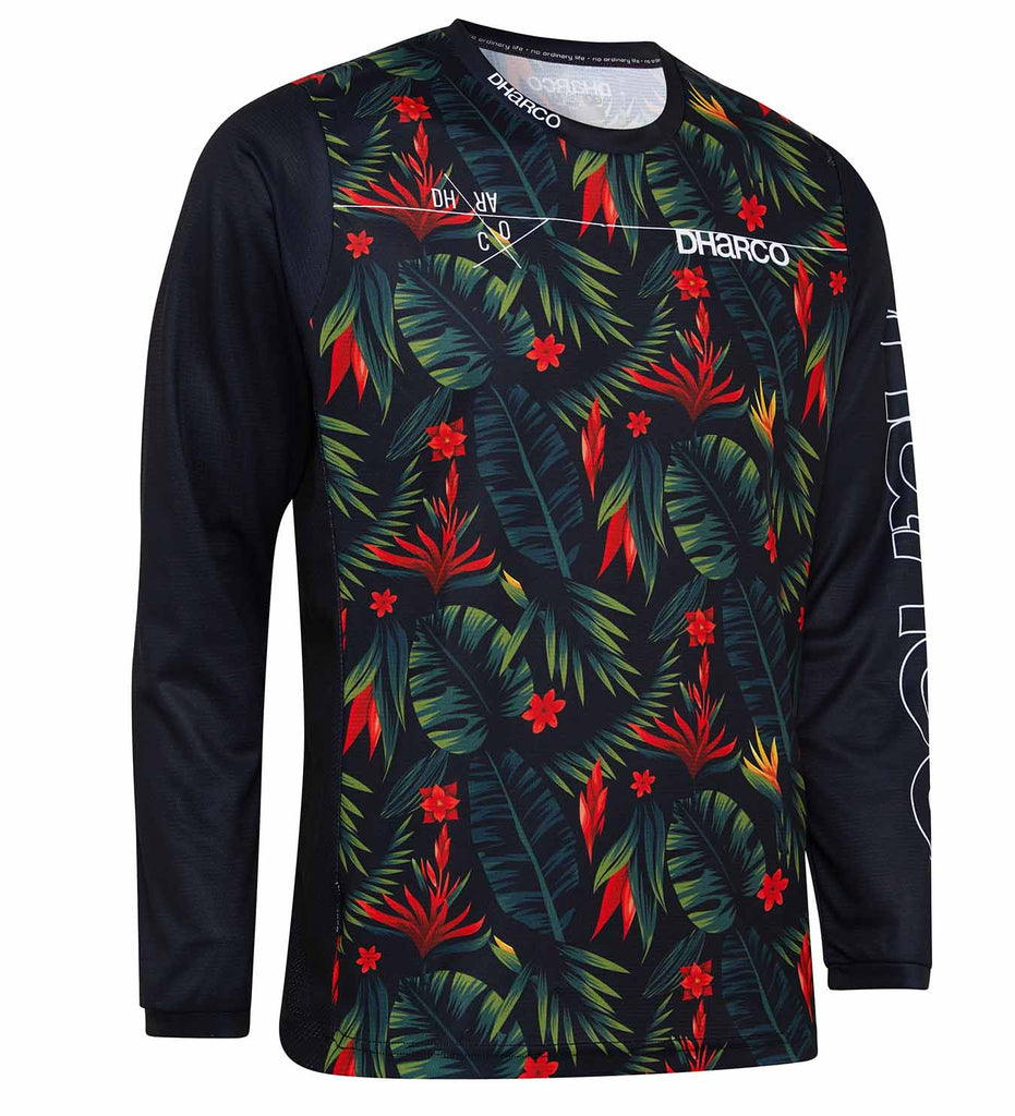 A photo of the Tropical DH Long Sleeve jersey, showing a red and green pattern of monstera and palm leaves, lobster claw and bird of paradise flowers of the torso. The DHaRCO logo is printed across the collar.