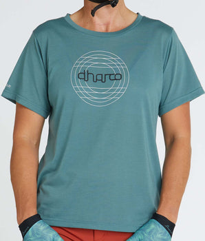 A photo of the front of the Thrills Tech Tee, showing a white geometric design with the DHaRCO logo on an aqua blue shirt.
