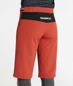 A photo of the back of the Brick Gravity Shorts, showing the black contract panel above the padded rear, with the DHaRCO logo printed on it.