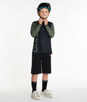 A photo of a young rider wearing the Black Youth Gravity Shorts.