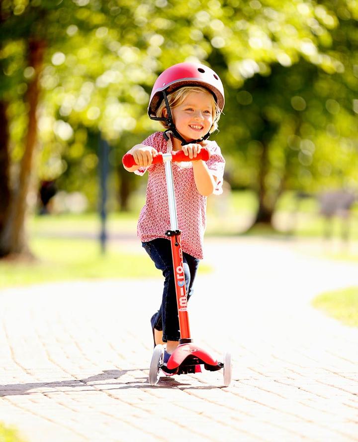Girl on Micro Mini Deluxe Kick Scooter Red