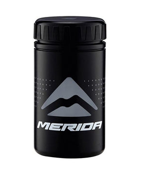 A photo of the Merida Tool Storage Bottle - a small black canister with a screw top that has the Merida logo on the side of it, with a geometric pattern. The tool bottle is the perfect size to fit into the water bottle cage on most bikes