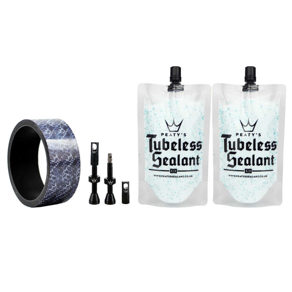 A photo of the rim tape, valves, and two pouches of tubeless sealant, as included in the kit.